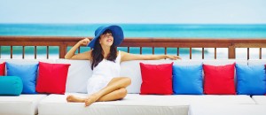 woman lounging on a couch by the ocean Dr. Joe Thomas Dentistry