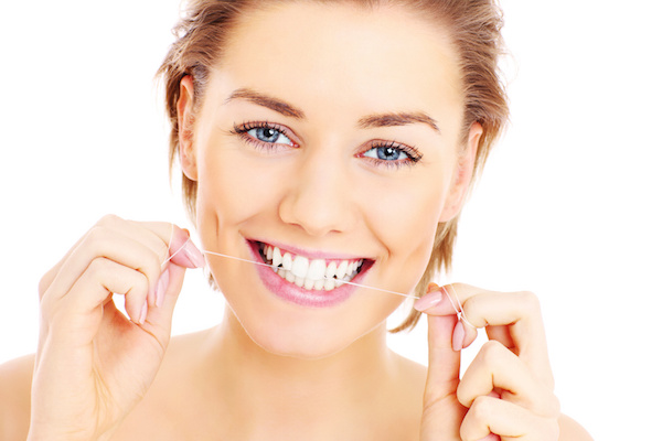 Flossing teeth, woman, smiling Dr. Joe Thomas Dentistry